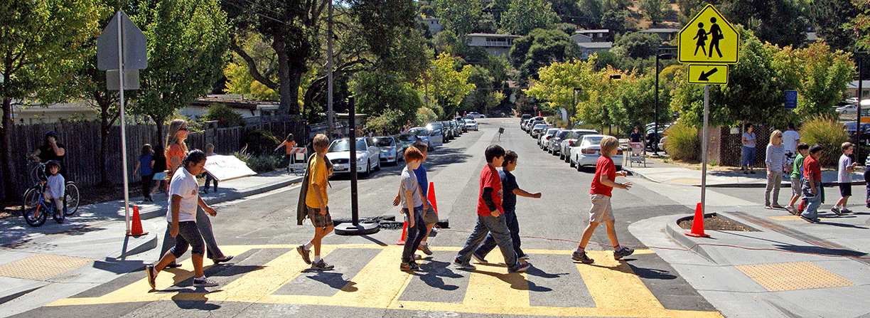 Group of school children crossing a street safely