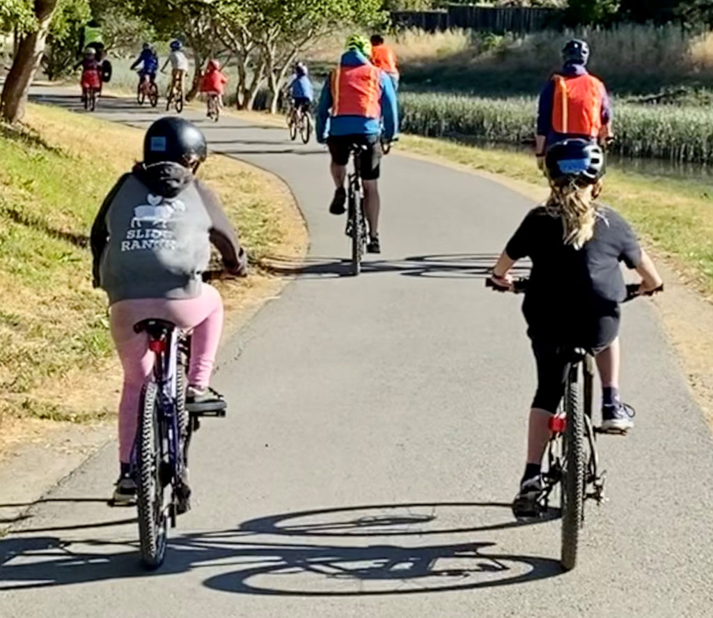 Group of bikers riding along a path