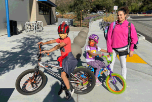 Mother with two children on bicycles