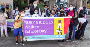 Students hold banner reading 