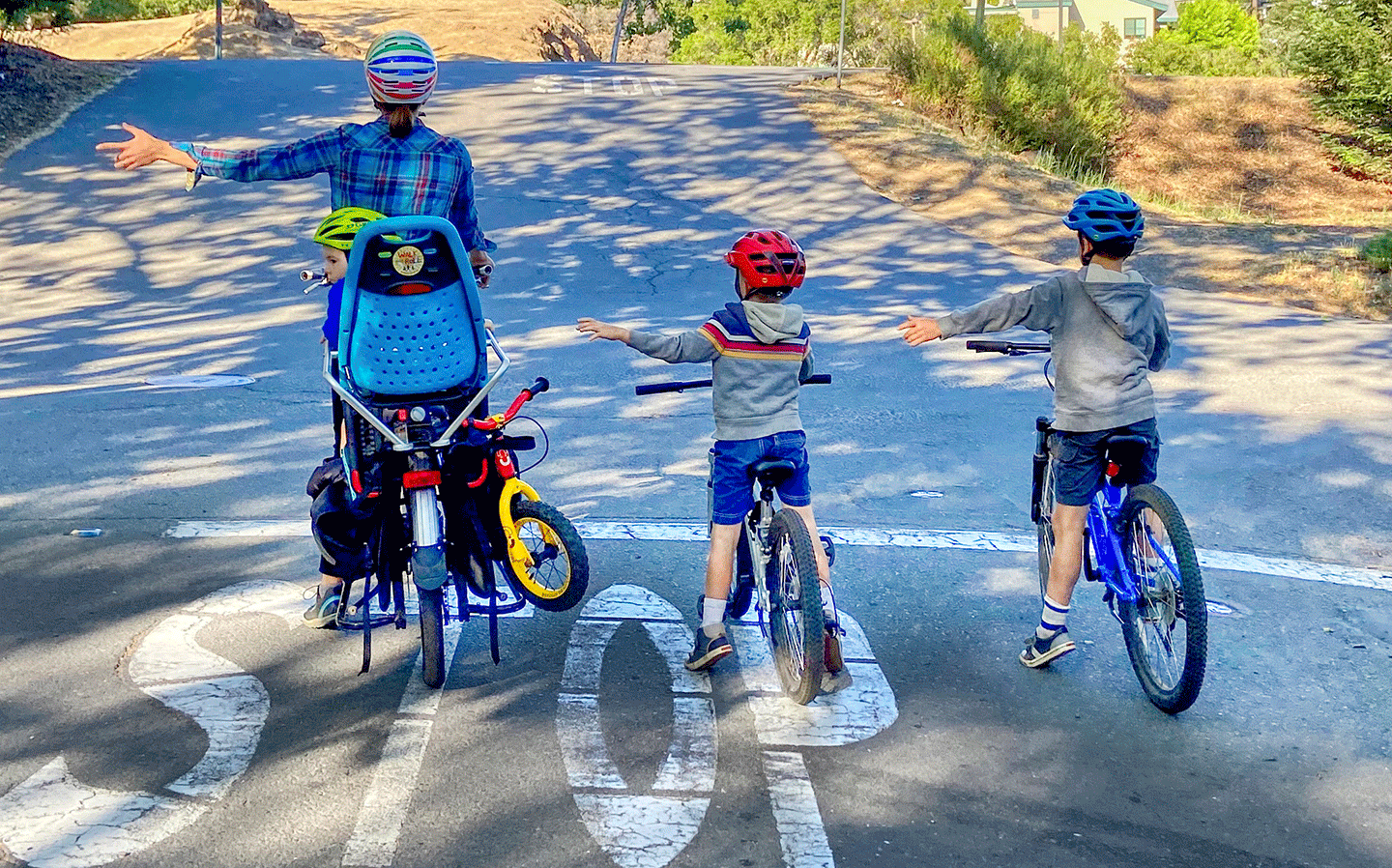 parent and 2 children cycling together